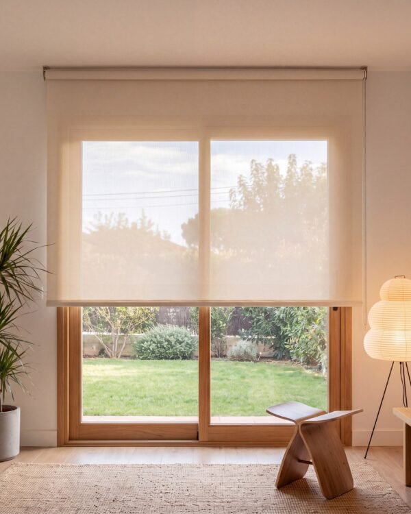Estor enrollable screen de poliéster 5% Beige claro (0208) instalado en un salón con ventana corredera